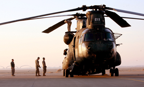 Soldiers examine their CH-47 Chinook helicopter before mission CH-47 Chinook Helicopter